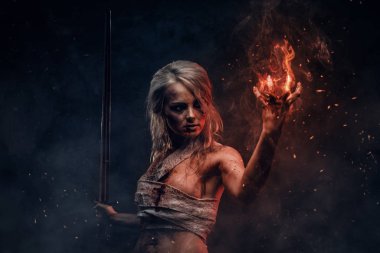 Naked Fantasy woman warrior wearing rag cloth stained with blood and mud in the heat of battle. Cosplayer as Ciri from The Witcher