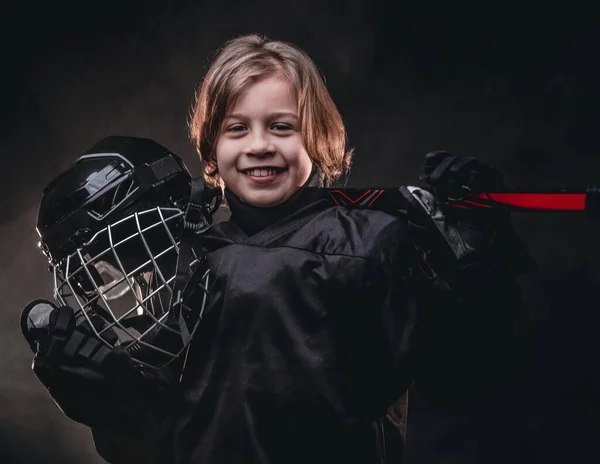 8-10 year old boy, hockey player boy posing in uniform with hockey gear for a photoshot in a studio — Stock Photo, Image