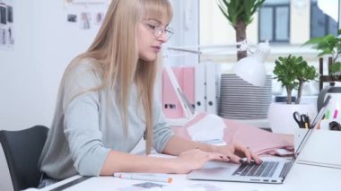 Young woman is working in the light office