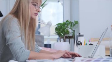 Young woman is working in the light office