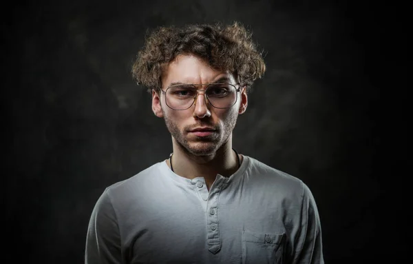 Serious student wearing casual clothes and amulet posing in the studio for a photoshoot — Stock Photo, Image