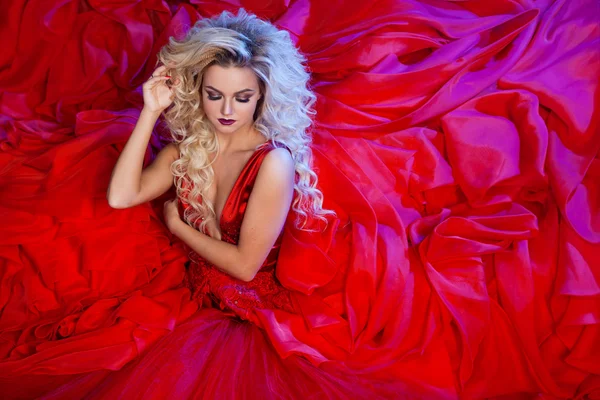 Fashion photo of young magnificent woman in red dress. Studio portrait — Stock Photo, Image