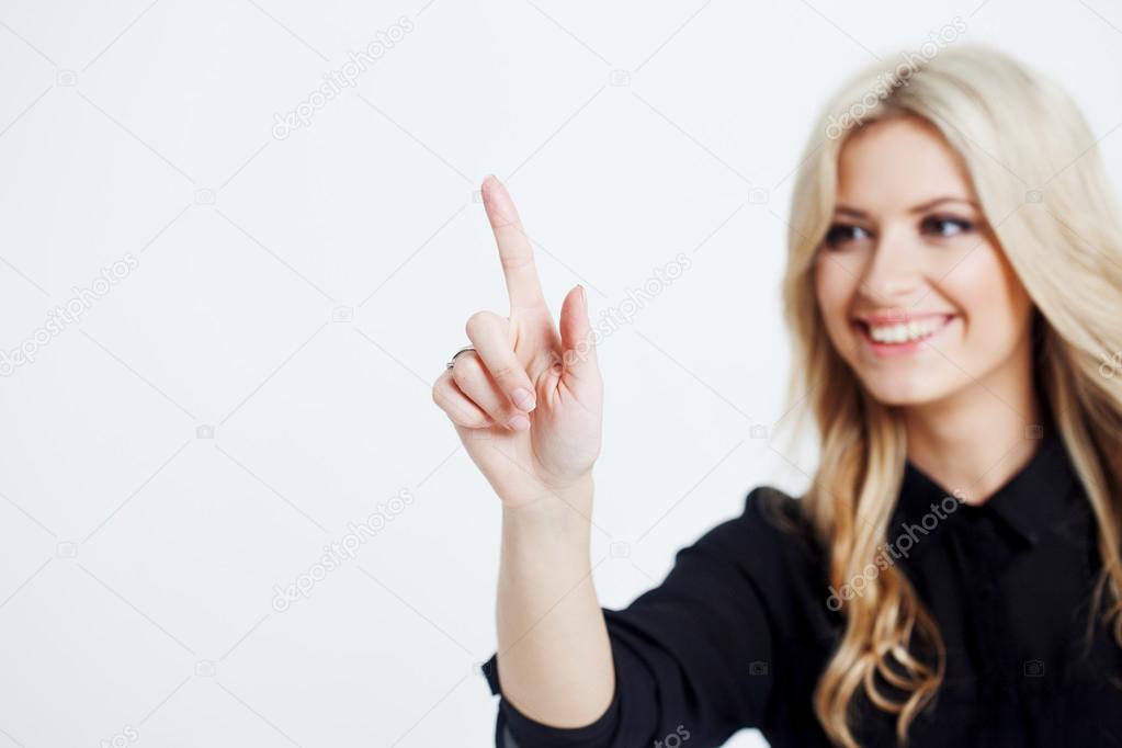 Confident business lady, touching finger to screen, touching digital screen with finger, place for your text or design. Focus on hand