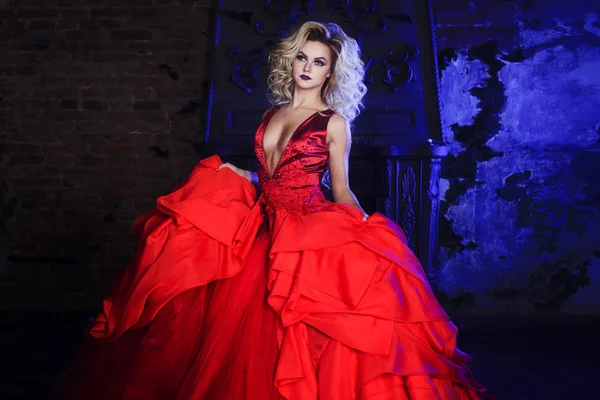 Fashion photo of young magnificent woman. Running towards camera. Seductive blonde in red dress with fluffy skirt — Stock Photo, Image