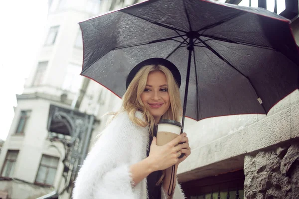 Femme gaie dans la rue buvant du café le matin — Photo