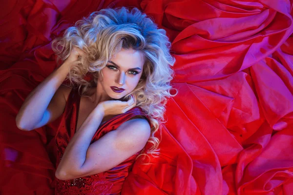 Fashion photo of young magnificent woman in red dress. Studio portrait — Stock Photo, Image