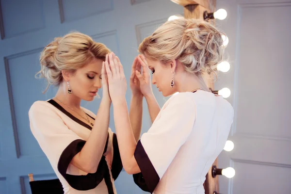 Young attractive woman, stylish. Attractive girl in evening dress, the reflection in the mirror in the background — Stock Photo, Image