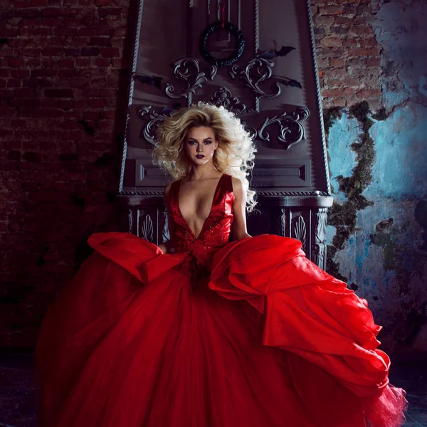 Foto de moda de jovem mulher magnífica. Correndo em direção à câmera. Loira sedutora em vestido vermelho com saia fofa — Fotografia de Stock