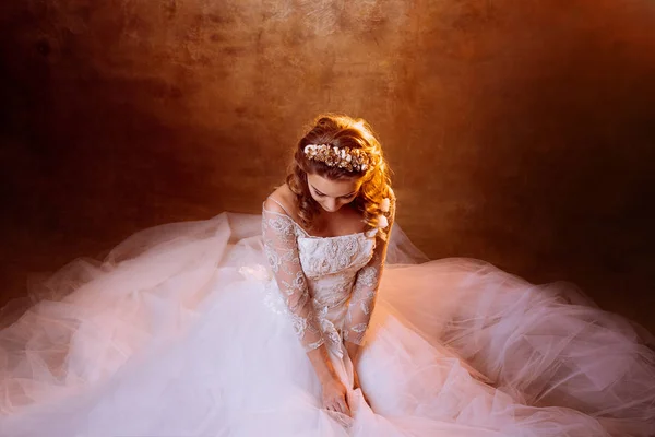 Schöne Braut im luxuriösen Hochzeitskleid, Porträt in goldenen Tönen, Effekte der Blendung — Stockfoto