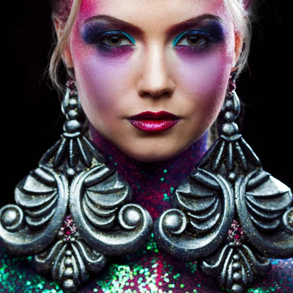 Young attractive blonde girl in bright art-makeup, high hair, body painting. Rhinestones and glitter — Stock Photo, Image