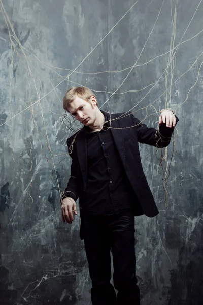 Young man tries to break the shackles. Concept of manipulation and slavery — Stock Photo, Image