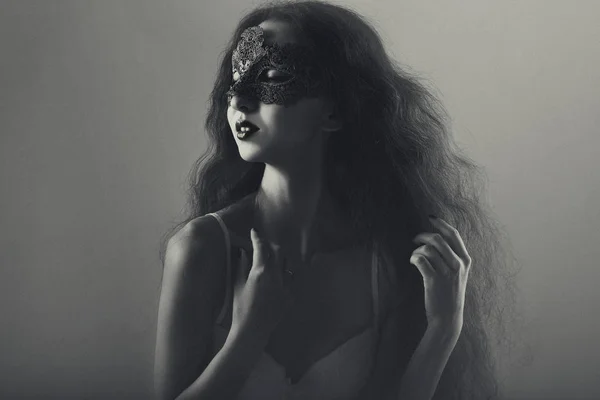 Cute young girl with long flowing hair in masquerade mask — Stock Photo, Image