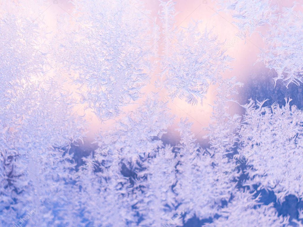 Real frosty pattern on the window. Winter background. Frosted glass