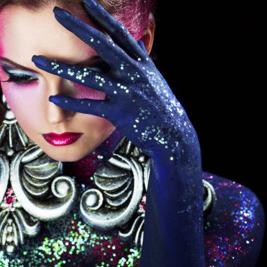 Parlak sanat-makyaj, yüksek saç, vücut boyama genç çekici sarışın kız. Yüzünde palmiye