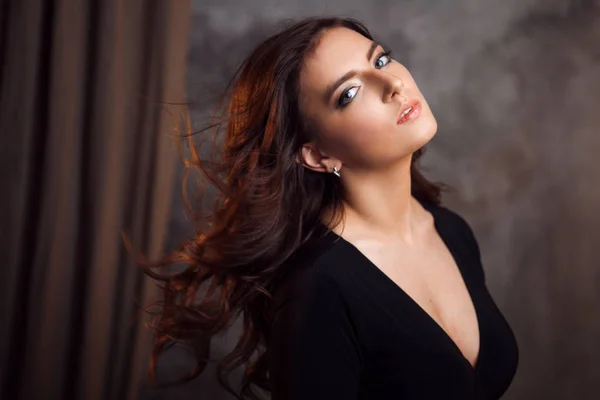 Delightful portrait of a woman brunettes, hair flying on the wind, sloppy styling — Stock Photo, Image