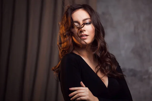 Delightful portrait of a woman brunettes, hair flying on the wind, sloppy styling — Stock Photo, Image