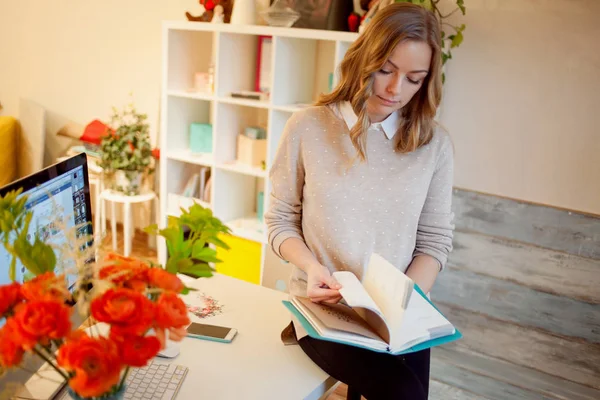 Jeune femme d'affaires assise au bureau et travaillant. Belle femme remplit planificateur — Photo