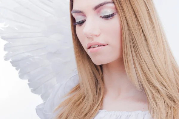 An angel from heaven. Young, wonderful blonde girl in the image of an angel with white wings. — Stock Photo, Image