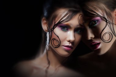 Mysterious portrait with reflection. Alter-ego. Girl with bright makeup and wet hair. Black background clipart