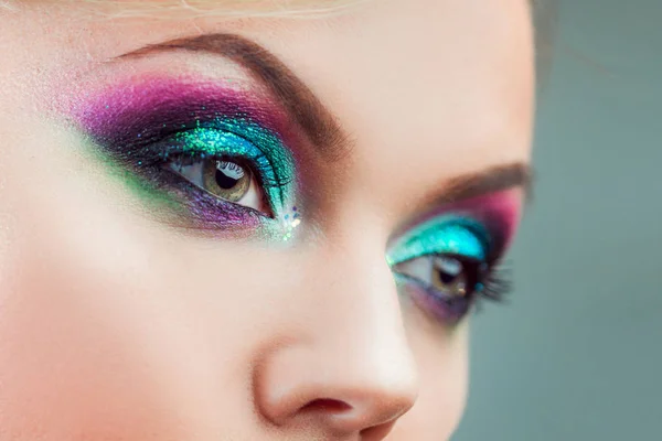 Portrait of young attractive blonde woman. Makeup close-up, green and blue tone — Stock Photo, Image