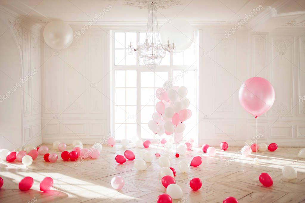 Luxurious living room with large window to the floor. Palace is filled with pink balloons