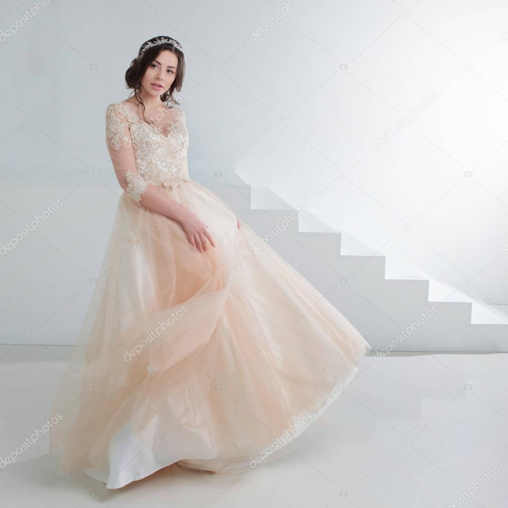 Portrait of a beautiful girl in a wedding dress. Bride in a luxurious dress, in a beautiful white interior