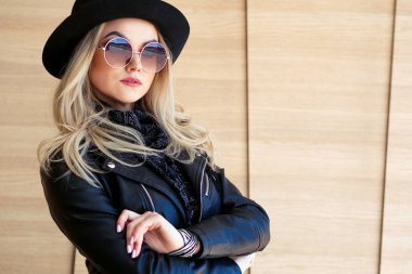 Komik ve güzel sarışın güneş gözlüğü ve şapka. Trendy kız portre açık. Şapka tutan