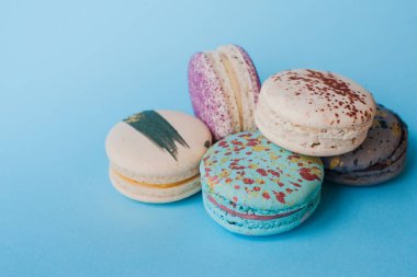 Mavi bir arka plan üzerinde renkli macarons Fransız