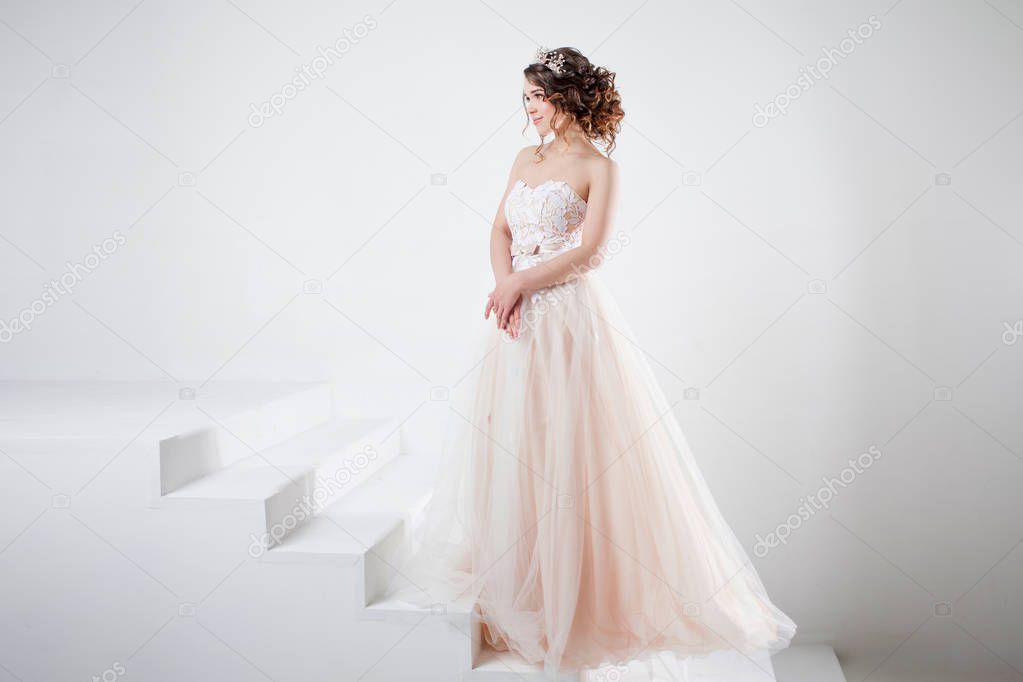 Concept of bride going towards future happiness. Portrait of a beautiful girl in a wedding dress.