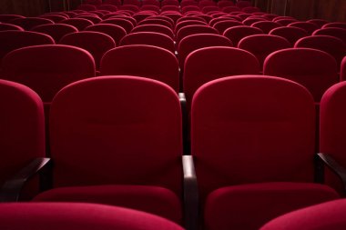 Empty cinema hall. Rows of red chairs. The crisis in film distribution clipart
