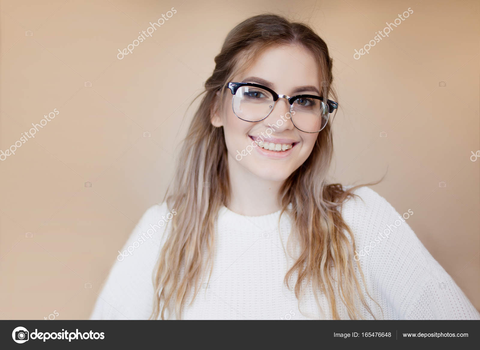 Happy and beautiful girl with glasses and braces. Young woman smiling —  Stock Photo © KrisCole #165476648