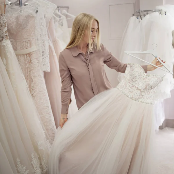 Gyönyörű lány esküvői ruha kiválasztása. Boutique menyasszonyi divat, vállalkozó nő — Stock Fotó