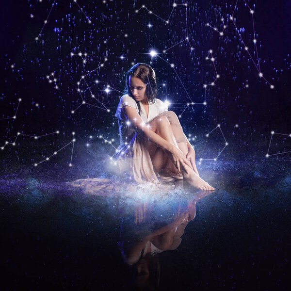 Photo art, young woman dreams to the starry sky. Elements of this image furnished by NASA.