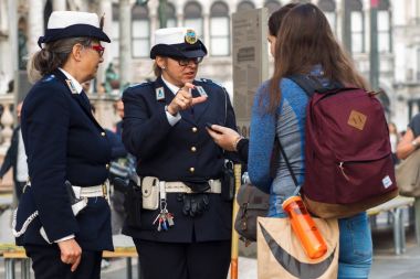 VENICE, ITALY - OCTOBER 6 , 2017: Women in uniform advise tourists, Venice clipart
