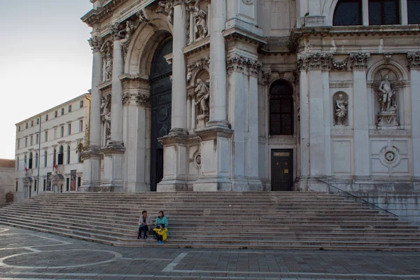 VENICE, ITALY - 7 октября 2017 года: Собор Санта-Мария-делла-Салют, люди сидят на ступеньках храма — стоковое фото