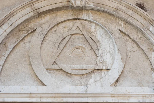 Eye in the pyramid, the bas-relief on the wall of the Church — Stock Photo, Image