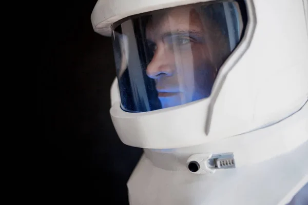 Astronaut in a helmet looks down. Fantastic space suit. Exploration of outer space. — Stock Photo, Image
