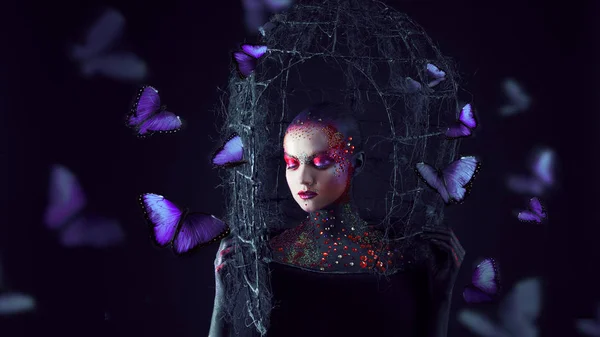 Soul breaks free from the cage. Young attractive girl in bright art-makeup, a lot of butterflies — Stock Photo, Image