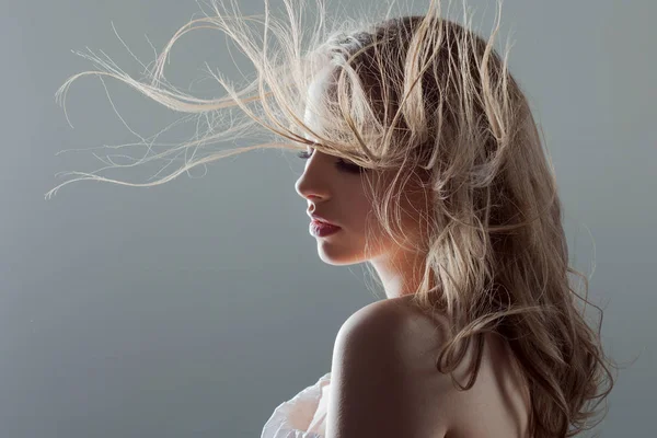 Mooie jonge vrouw met prachtige Oorhangers, portret close-up. vliegende haren — Stockfoto