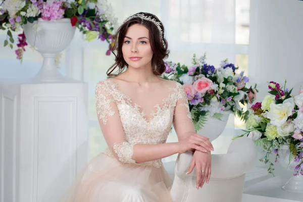 Portret van mooi meisje in een luxe trouwjurk. Interieur versierd met bloemen — Stockfoto