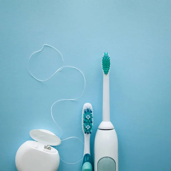 A set of sonic toothbrush, dental floss and classic toothbrush — Stock Photo, Image