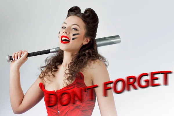 Dont forget Valentines day. Woman in red with a bat in war paint. Laughs and threatens — Stock Photo, Image