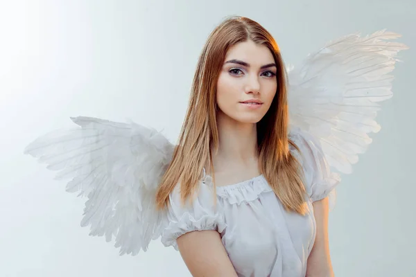 An angel from heaven. Young, wonderful blonde girl in the image of an angel with white wings. — Stock Photo, Image