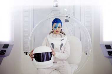 Woman astronaut on a futuristic spaceship. clipart