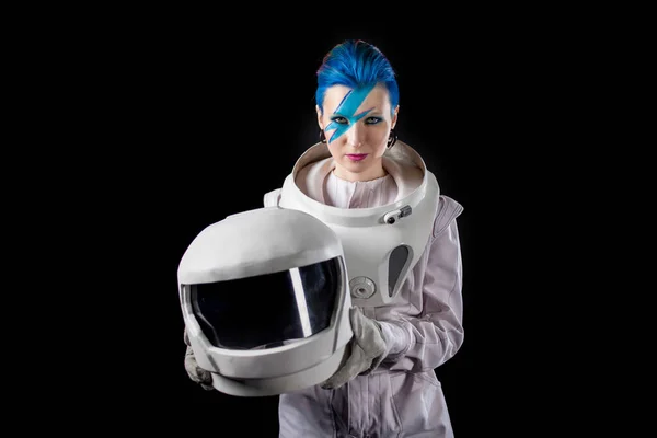 Astronaut on a black background, a young woman with face art in the space suit. Helmet in hands — Stock Photo, Image