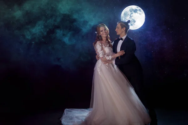 Μυστηριώδη και ρομαντική συνάντηση, την νύφη και γαμπρός κάτω από το φεγγάρι. Αγκαλιές μαζί. Μικτή τεχνική — Φωτογραφία Αρχείου