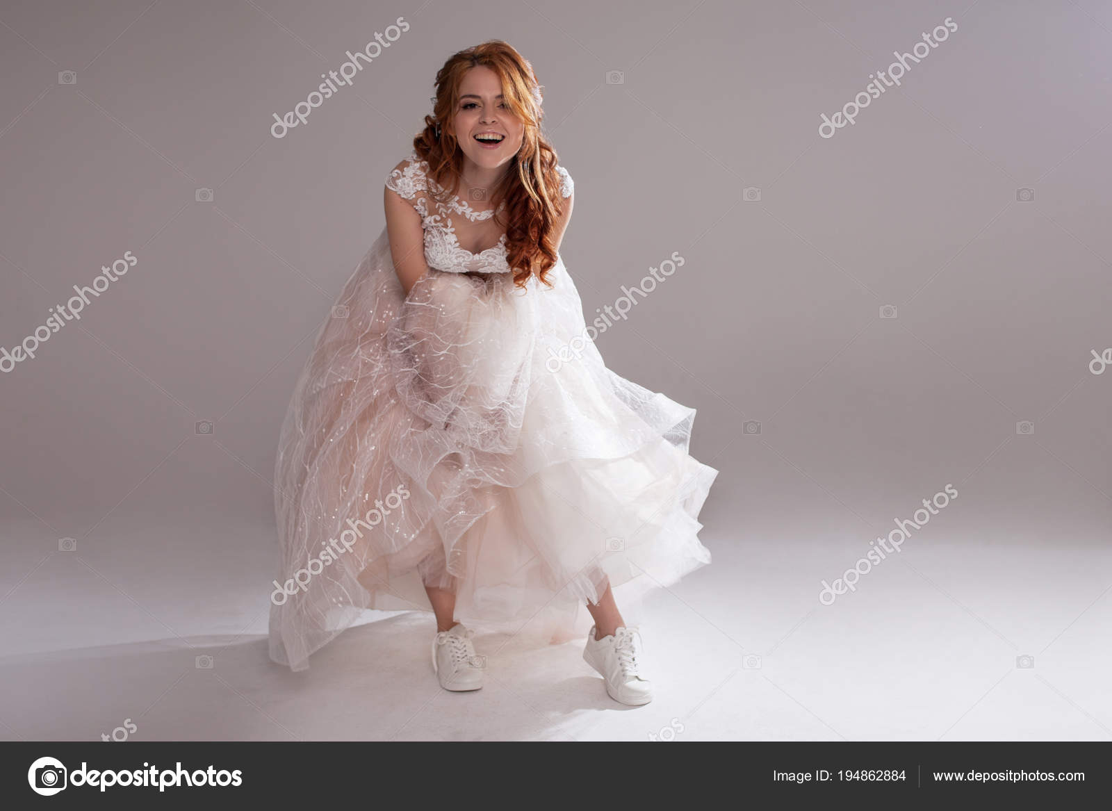 Charming Girl In Magnificent Wedding Dress And White Sneakers