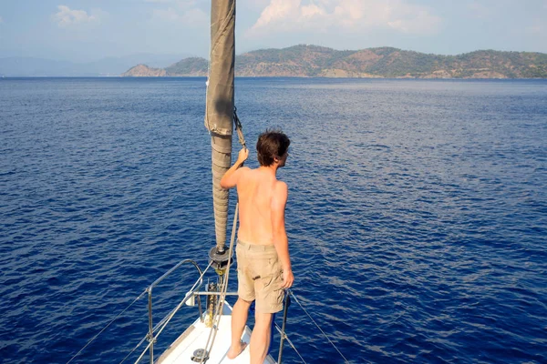 Man in shorts stands on the deck near the sail, sailing and yachting, concept. — Stock Photo, Image