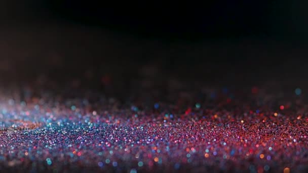 Mehrfarbige glitter magischen hintergrund. Defokussiertes Licht — Stockvideo