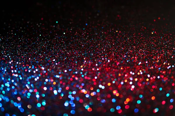 Multicolored shining glitter in focus and out of focus, abstract shiny background — Stock Photo, Image